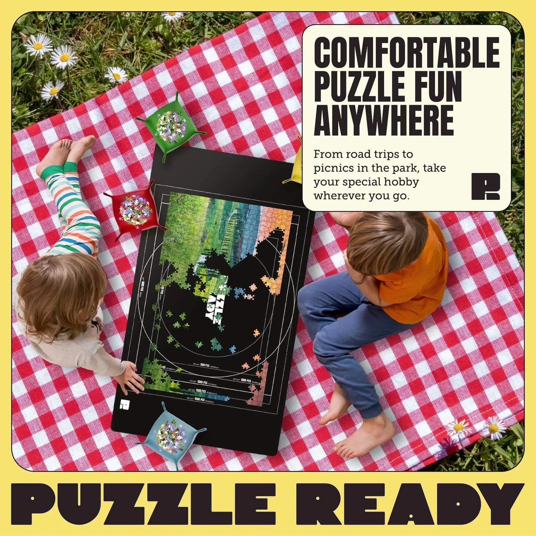 Portable Jigsaw Puzzle Mat with accessories on picnic blanket, ideal for puzzle and LEGO enthusiasts.